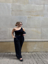 A blonde girl wears a pair of slacks